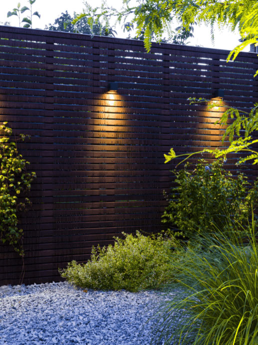 In-Lite Big cubid wall light on fence, illuminated